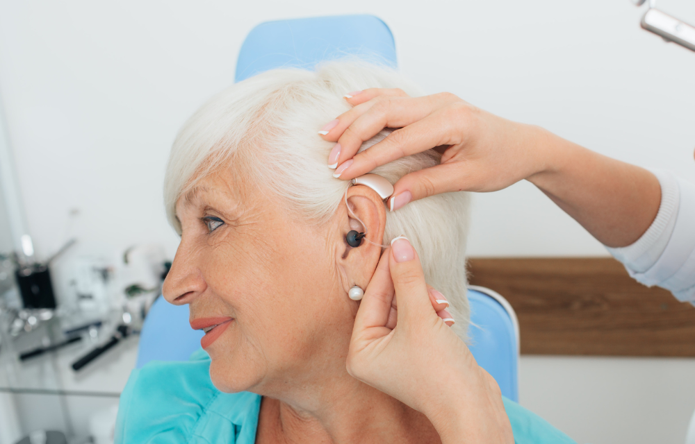 Woman having hearing aid fitted.