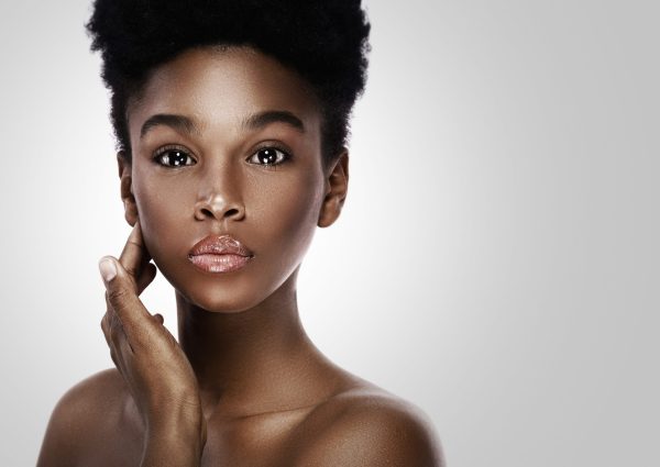 Photo of a woman with her hand touching her face